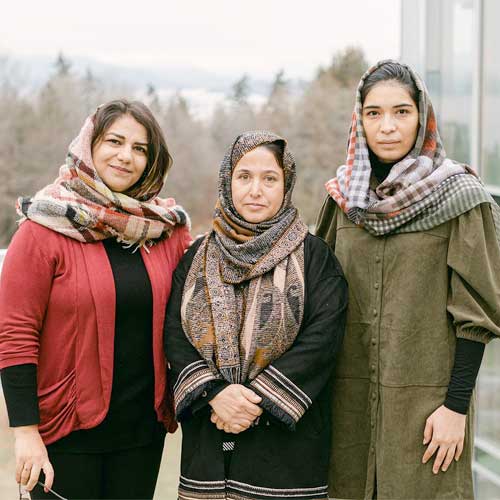 Three women in a group portrait.
