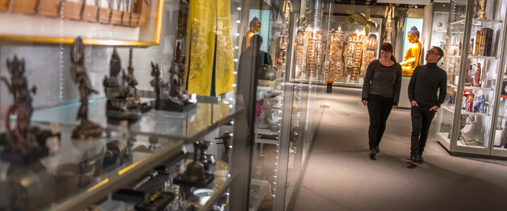 Two people walking through the galleries at the Museum of Anthropology.